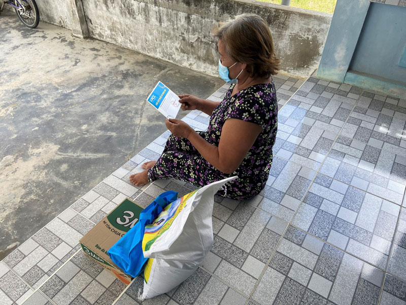 An elderly read the postcard from VPCL